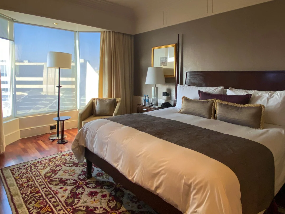 Woman completing a quiet bodyweight workout in a hotel room