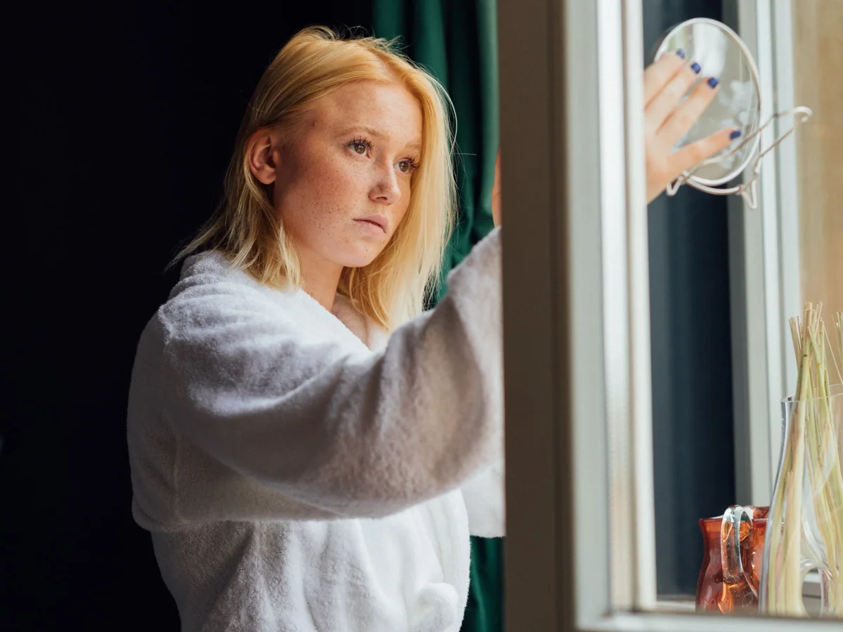 Woman unpacking and resetting her sleep routine after a weekend trip