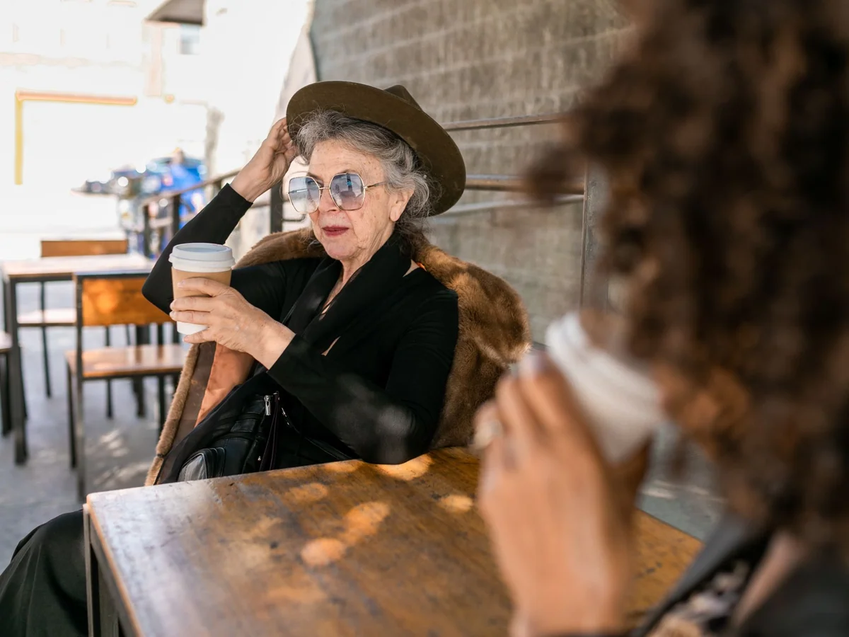 Woman reviewing a symptom journal beside a glass of water