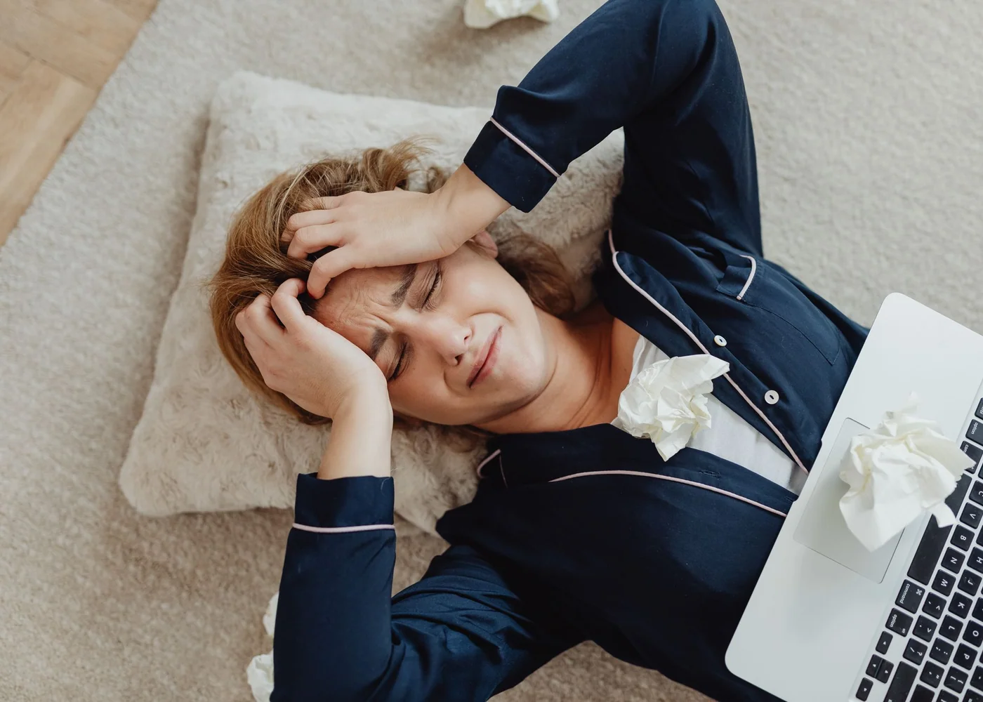 Woman writing a cycle and symptom note in a planner