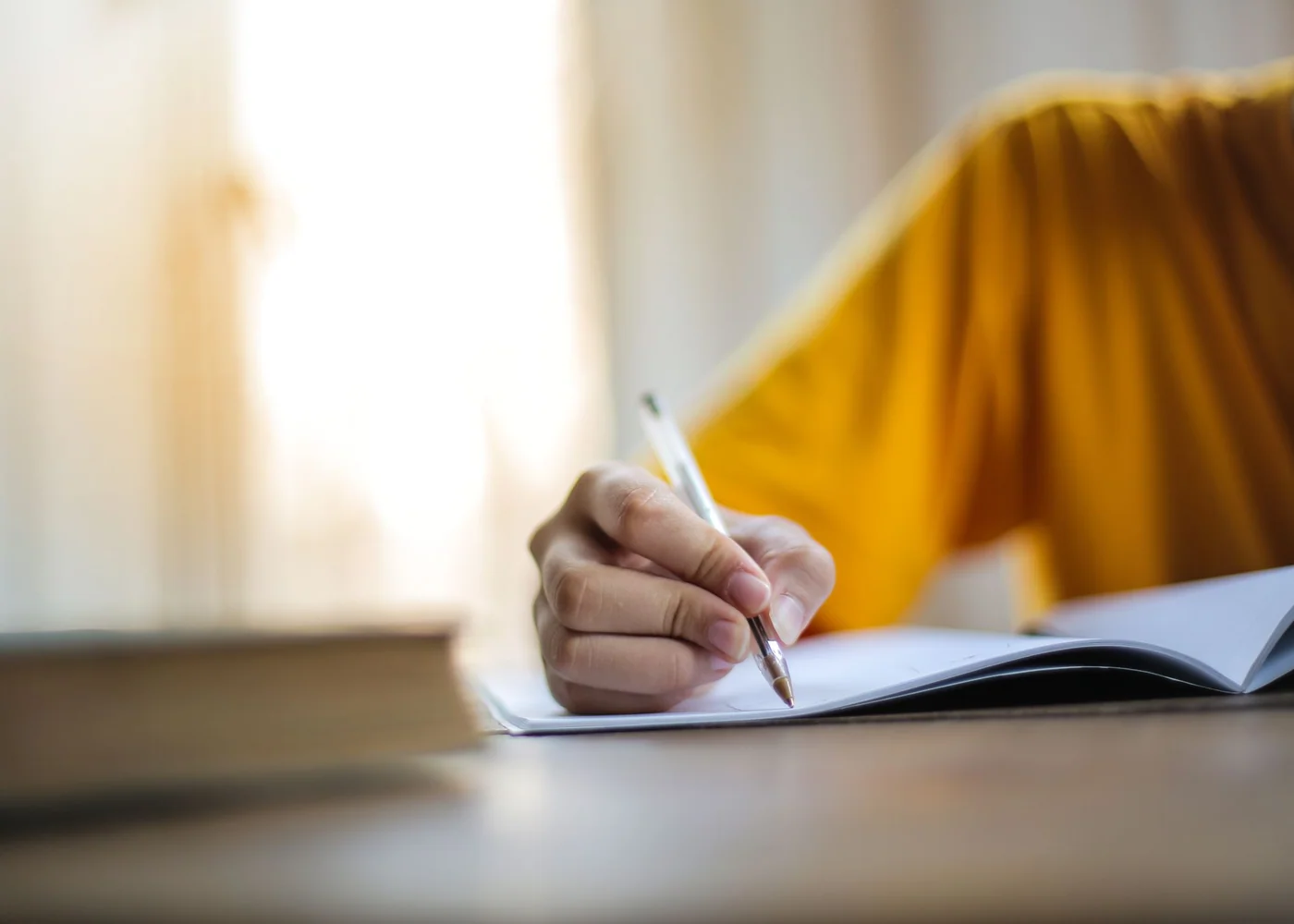 Woman reviewing a cycle and symptom journal at a table